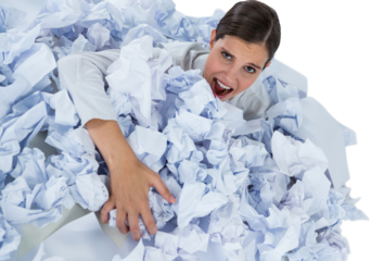 Portrait of unhappy businesswoman in heap crumpled paper