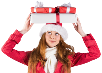 Festive redhead holding pile of gifts