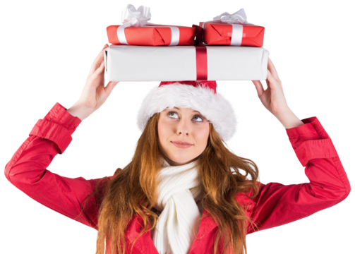 Festive redhead holding pile of gifts
