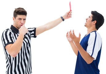 Portrait of referee showing red card to a player