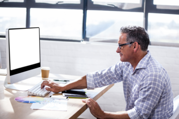 Profile view of a businessman working on computer