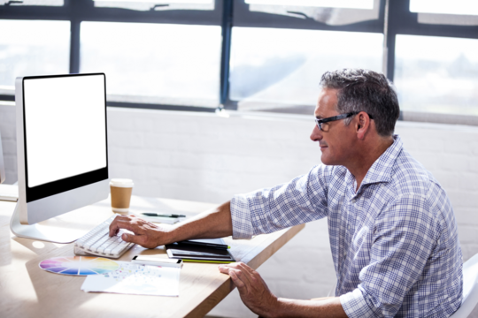 Profile view of a businessman working on computer - Powered by Adobe