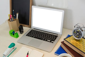 Laptop and various office accessories on table