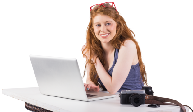 Pretty redhead working on laptop 