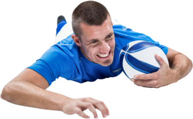 Confident rugby player lying in front with ball