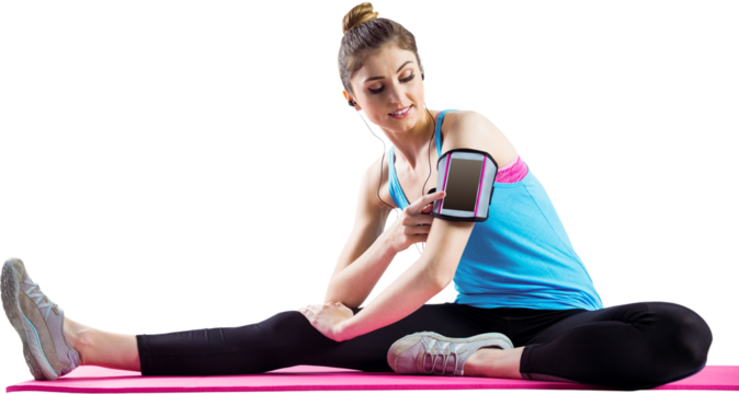 Fit woman listening music while exercising on mat