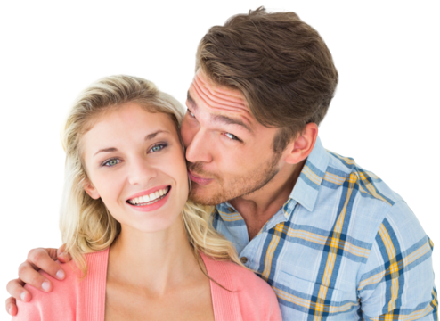 Handsome man kissing girlfriend on cheek