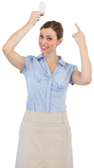 Classy businesswoman holding light bulb above her head