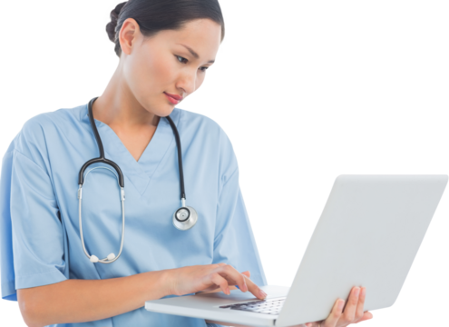 Concentrated surgeon using a laptop in hospital