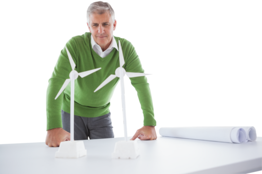 Man looking at windmill model on table