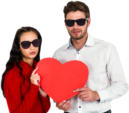 Portrait of couple with sunglasses holding paper heart - Powered by Adobe