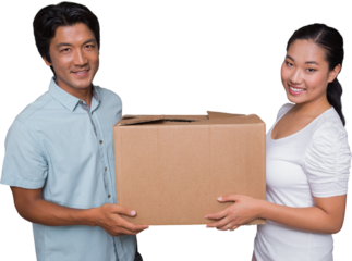 Happy couple holding a cardboard moving box
