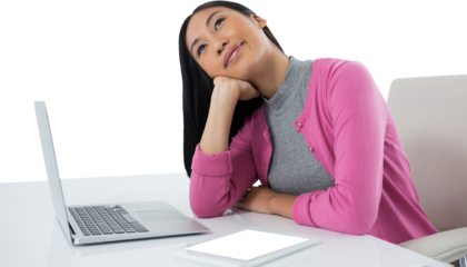 Female executive with laptop against white background
