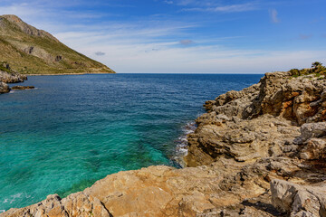Beautiful views of the turquoise sea surrounded by huge rocky walls and mountain vegetation.