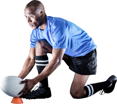 Rugby player looking away while keeping ball on kicking tee