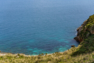 View of the beautiful blue sea falling between the mountain shores.