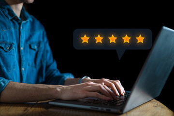 User give rating to service experience on online application for Customer review satisfaction feedback survey concept. 5 stars rating satisfied client. Dark background. Business concept on laptop - obrazy, fototapety, plakaty