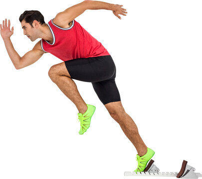 Fototapeta Confident male athlete running from starting blocks