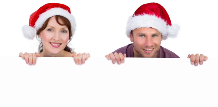 Couple both wearing santa hats