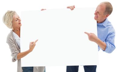 Mature couple smiling and holding card