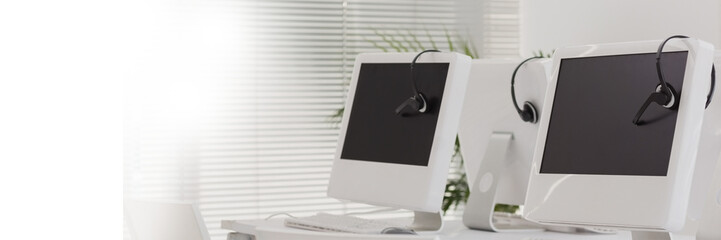 Fototapeta premium Computers with headphones on table