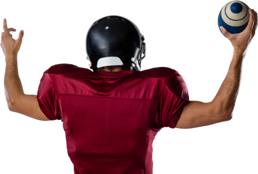 Rear view of player holding football with arms raised