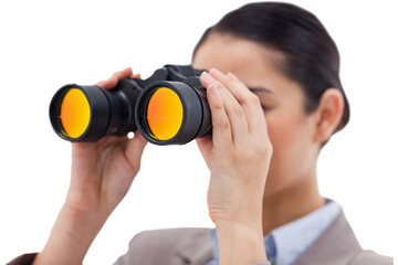 Brunette businesswoman looking through binoculars