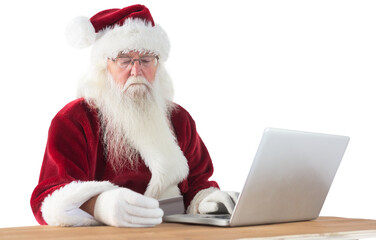 Santa pays with credit card on a laptop