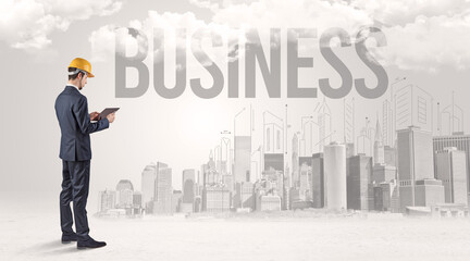 Fototapeta premium Young businessman with hard hat