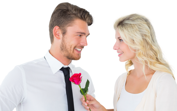 Handsome man smiling at girlfriend holding a rose
