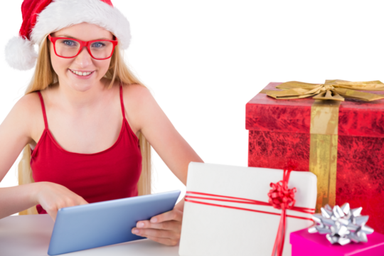 Festive blonde shopping online with tablet pc