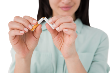 Smiling woman snapping cigarette in half