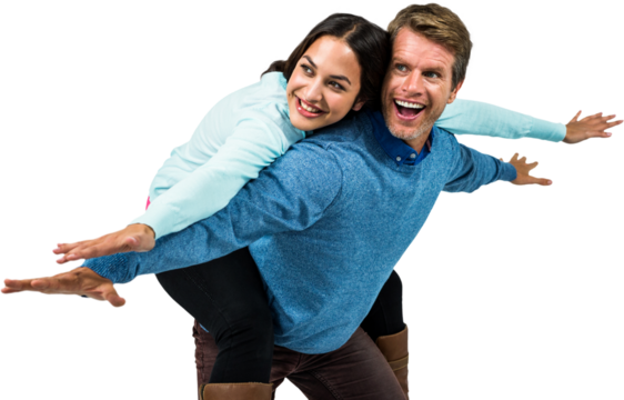 Cheerful couple wearing warm clothing with arms outstretched
