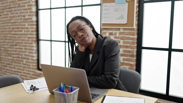 African american woman business worker tired using laptop at office