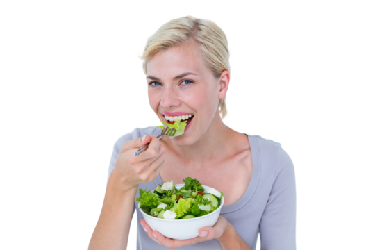Happy blonde woman holding bowl of salad