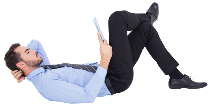 Businessman lying on floor using tablet  - Powered by Adobe