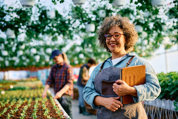 Portrait of happy plant nursery owner looking at camera.