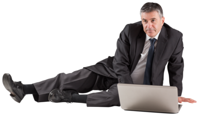 Mature businessman sitting using laptop