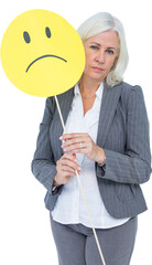 Obraz premium Businesswoman holding sad smiley face