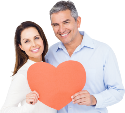 Happy couple holding big heart shape paper