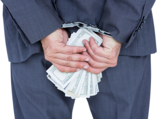 Rear view of businessman with handcuff and money