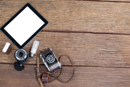 Close up of old fashioned camera with digital tablet on table - Powered by Adobe