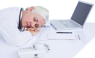 Tired female docotor sleeping on her desk