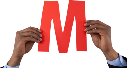 Cropped hand of businessman holding alphabet M