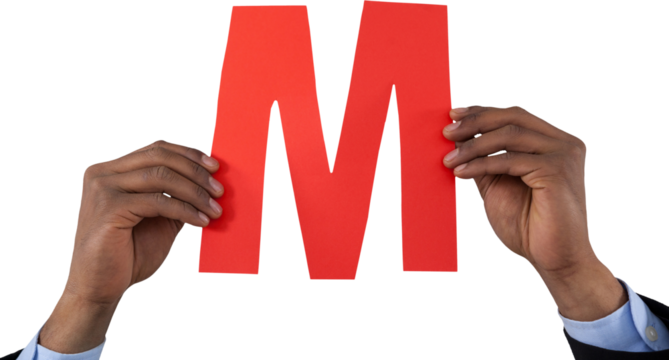 Cropped hand of businessman holding alphabet M