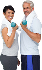 Portrait of a fit mature couple exercising with dumbbells