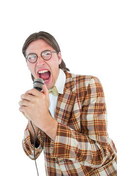 Happy geeky hipster singing with microphone 
