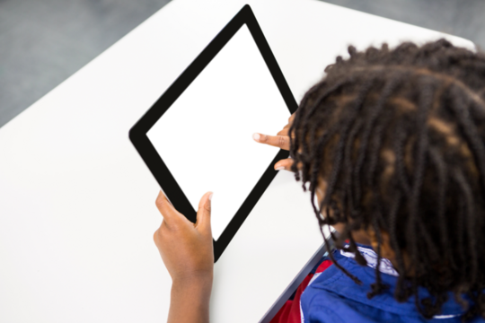Boy with digital tablet on table