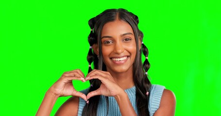 Happy woman, heart hands and face wink on green screen, background and studio for care, kindness or emoji. Portrait, winking and finger shape of girl, thank you and smile of trust, love or hope icon