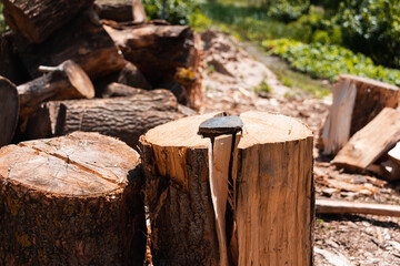 Tools of lumberjack, wedge and the chock. Harvesting firewood in the village.  Logs and timber on...